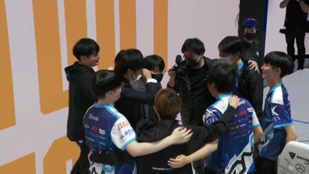 DetonatioN FocusMe celebrating on stage after making history by getting into Groups at Worlds 2021