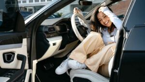 Valkyrae posing inside of her Lamborghini Urus