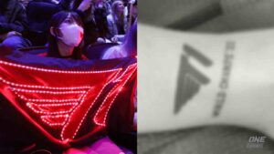 ONE Esports featured image showing fan holding T1 flag and fan who got T1 World Champs tattoo on leg