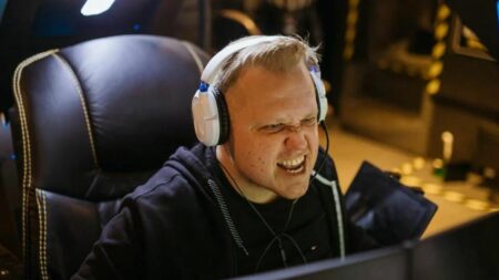 A man wearing white gaming headset while playing a video game, photo courtesy of Pexels