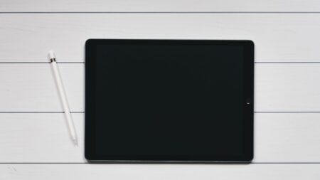 A tablet and an S-pen on top of a white table