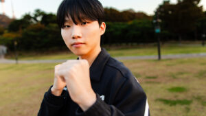 League of Legends Dplus KIA Canna with his fists up during a 2023 Worlds promo shoot