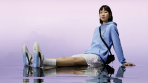 A girl wearing the Puma PlayStation merchandise