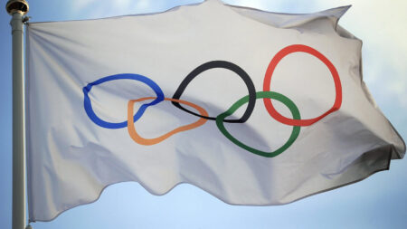 The Olympic flag seen high in the air