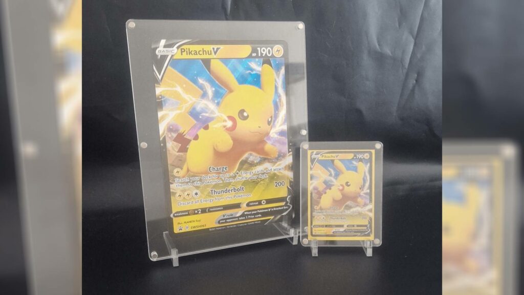 Cartas de Pokémon Pikachu grandes y pequeñas expuestas mediante soportes para cartas.