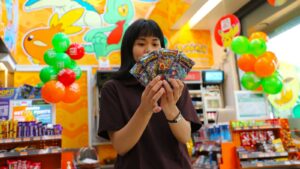 Pokemon and 7-Eleven Philippines collaboration featuring a girl holding card packs