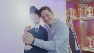 T1 CEO Joe March hugging Faker cutout at T1 gaming facility