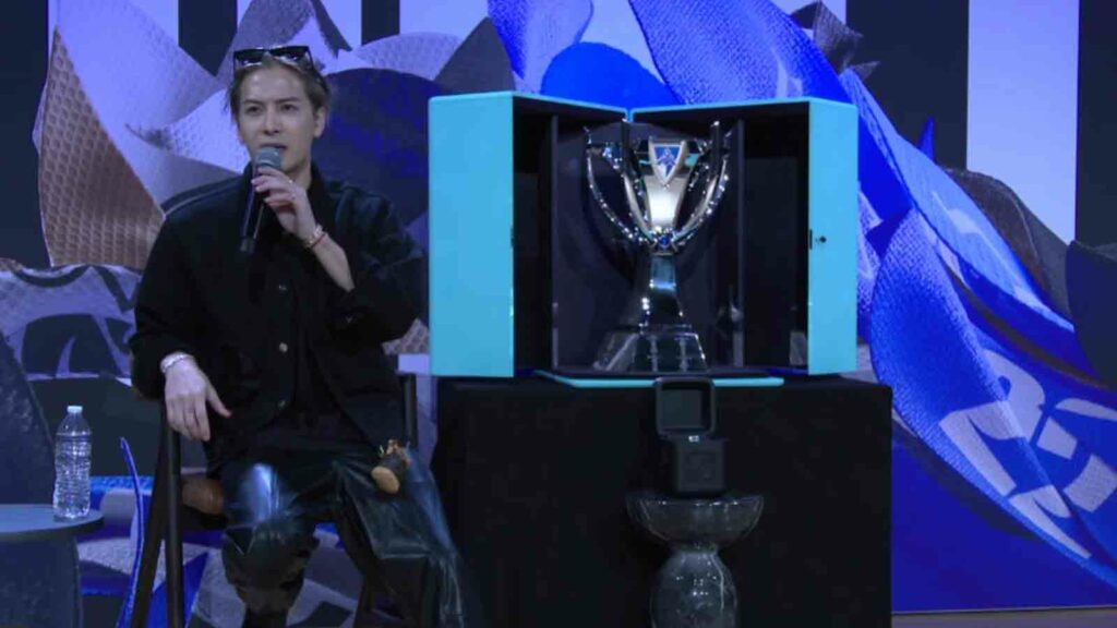 Jackson Wang speaking at Worlds 2022 Media Day sitting next to the Worlds trophy