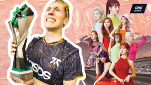 Fnatic's Jake "Boaster" Howlett holding the VCT LOCK//IN trophy after winning the first international event in the VCT 2023 season with Kpop stars Twice in the background